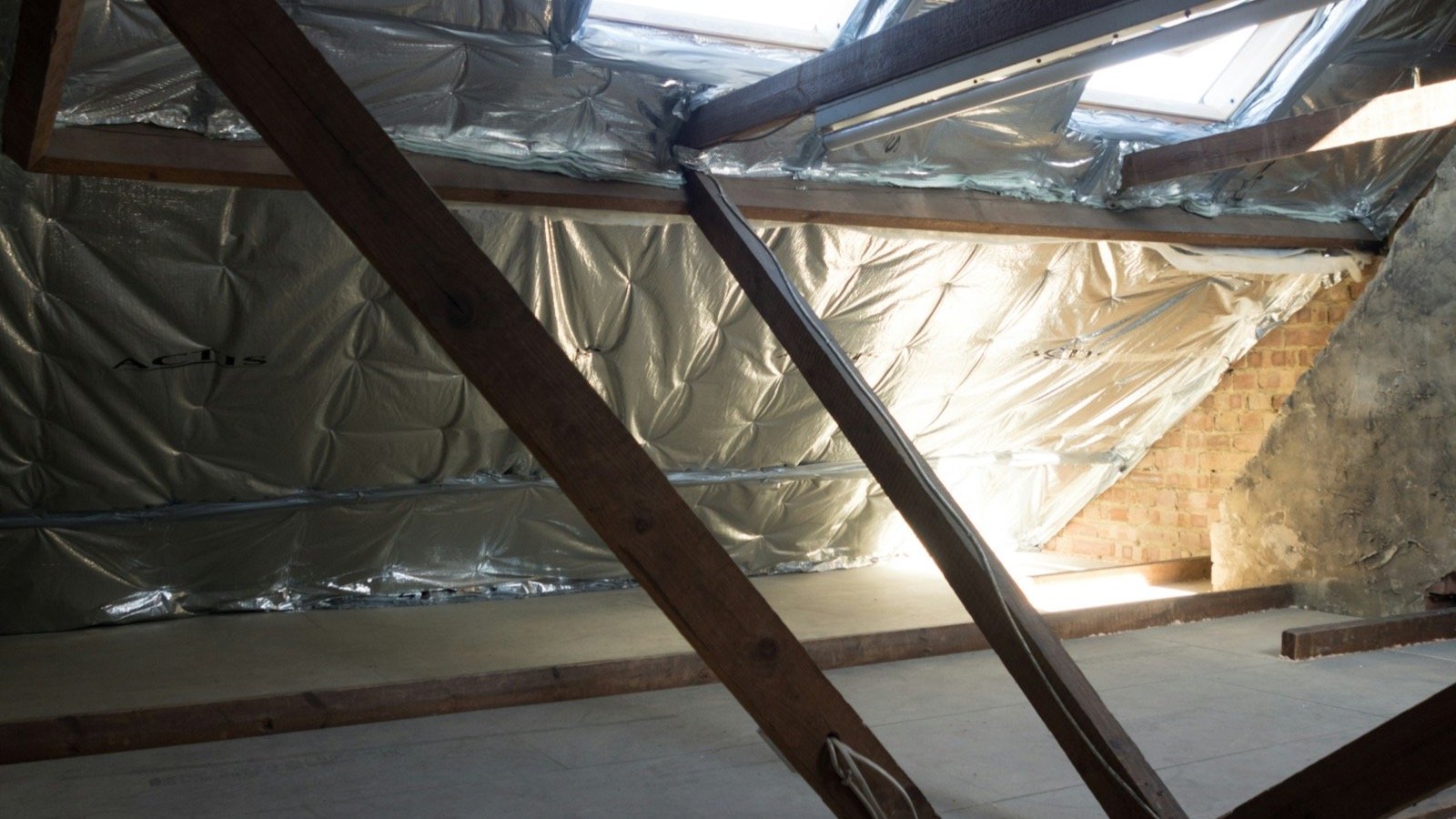 Residential attic interior showing insulation and roof structure