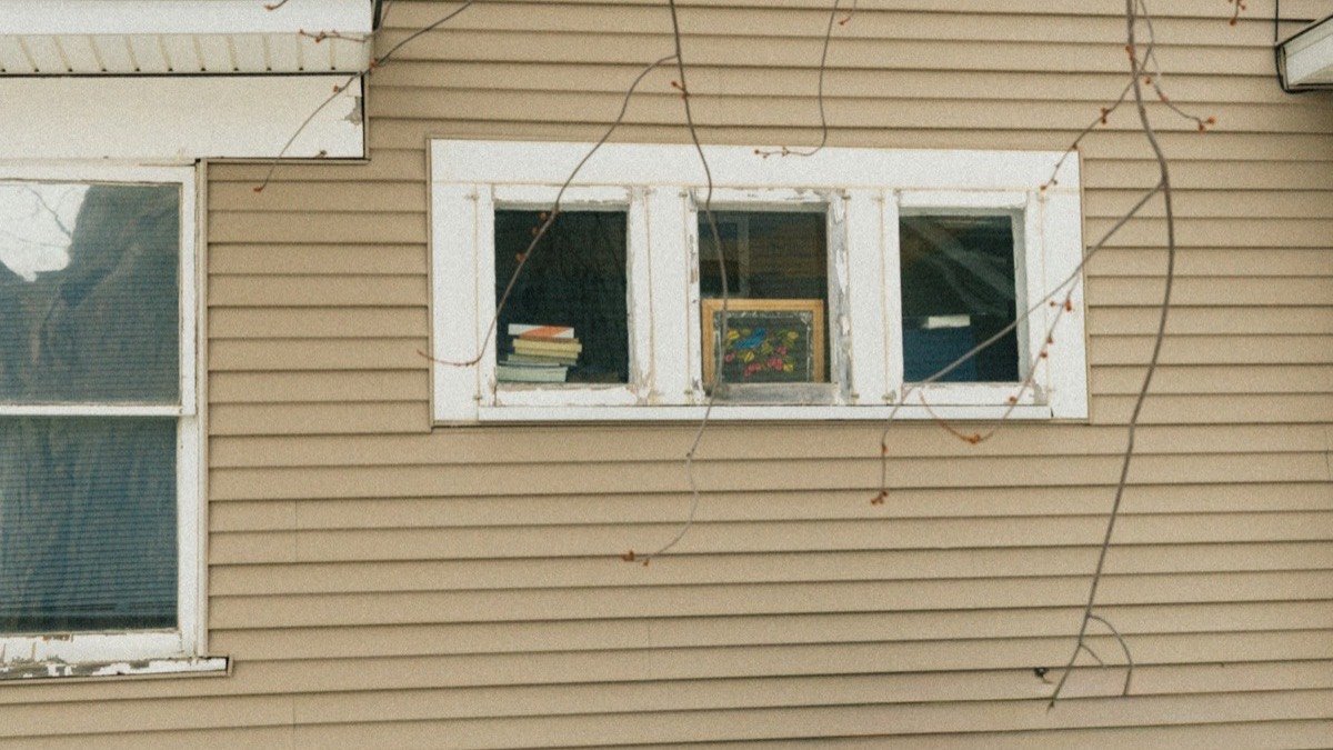 Two-storey house exterior with siding, trim and a shingled roofline