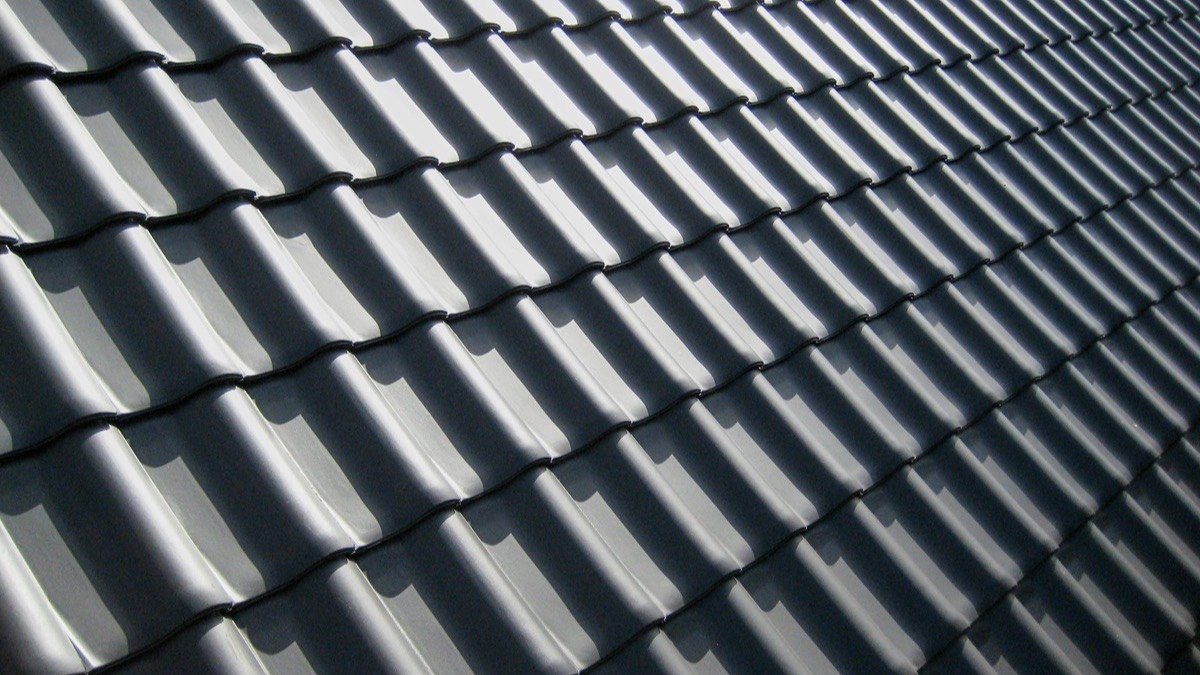 Rows of layered roof shingles seen at a low angle