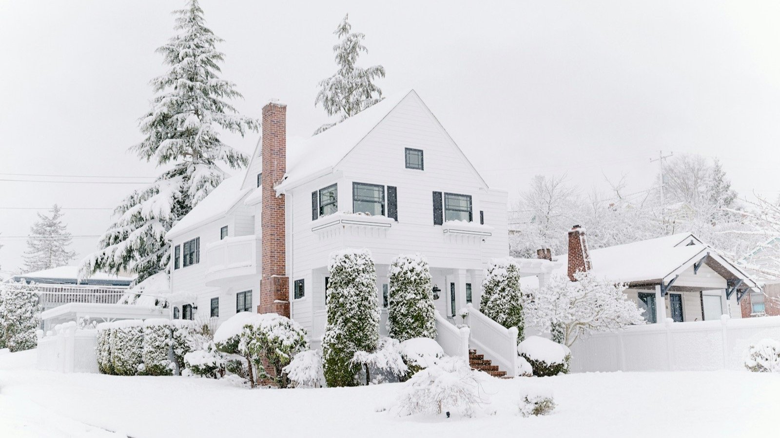 Snow-covered residential roof and rooflines during an Alberta winter