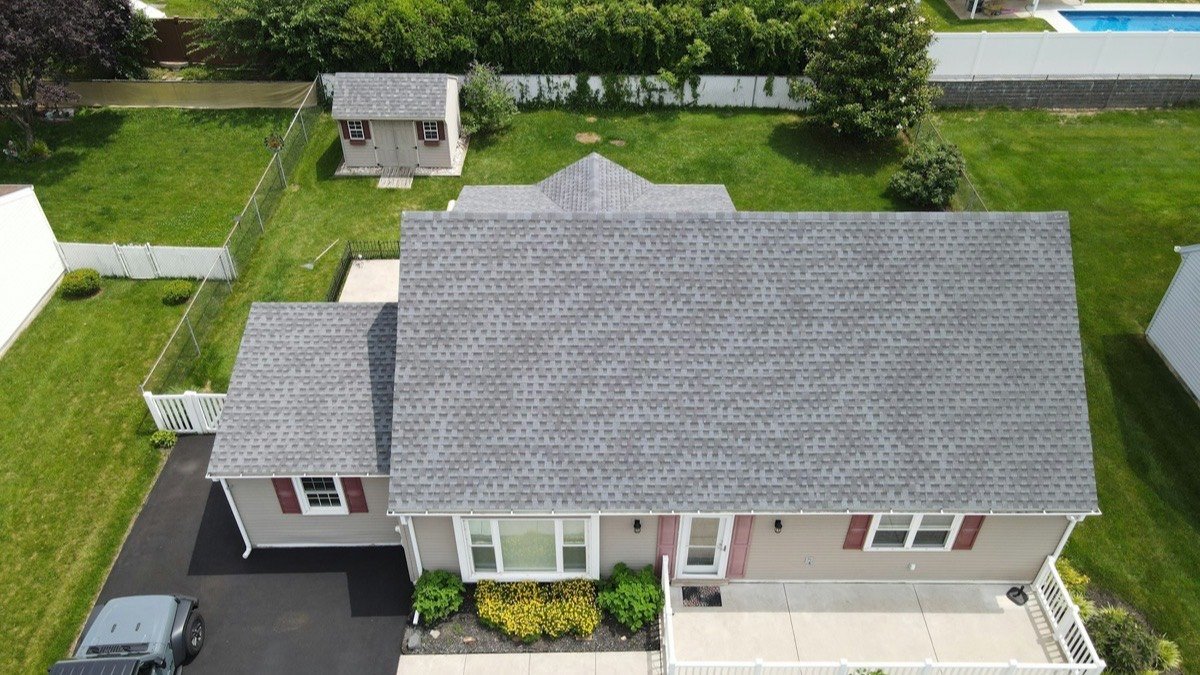 Aerial view of a finished asphalt shingle roof on a single-storey home