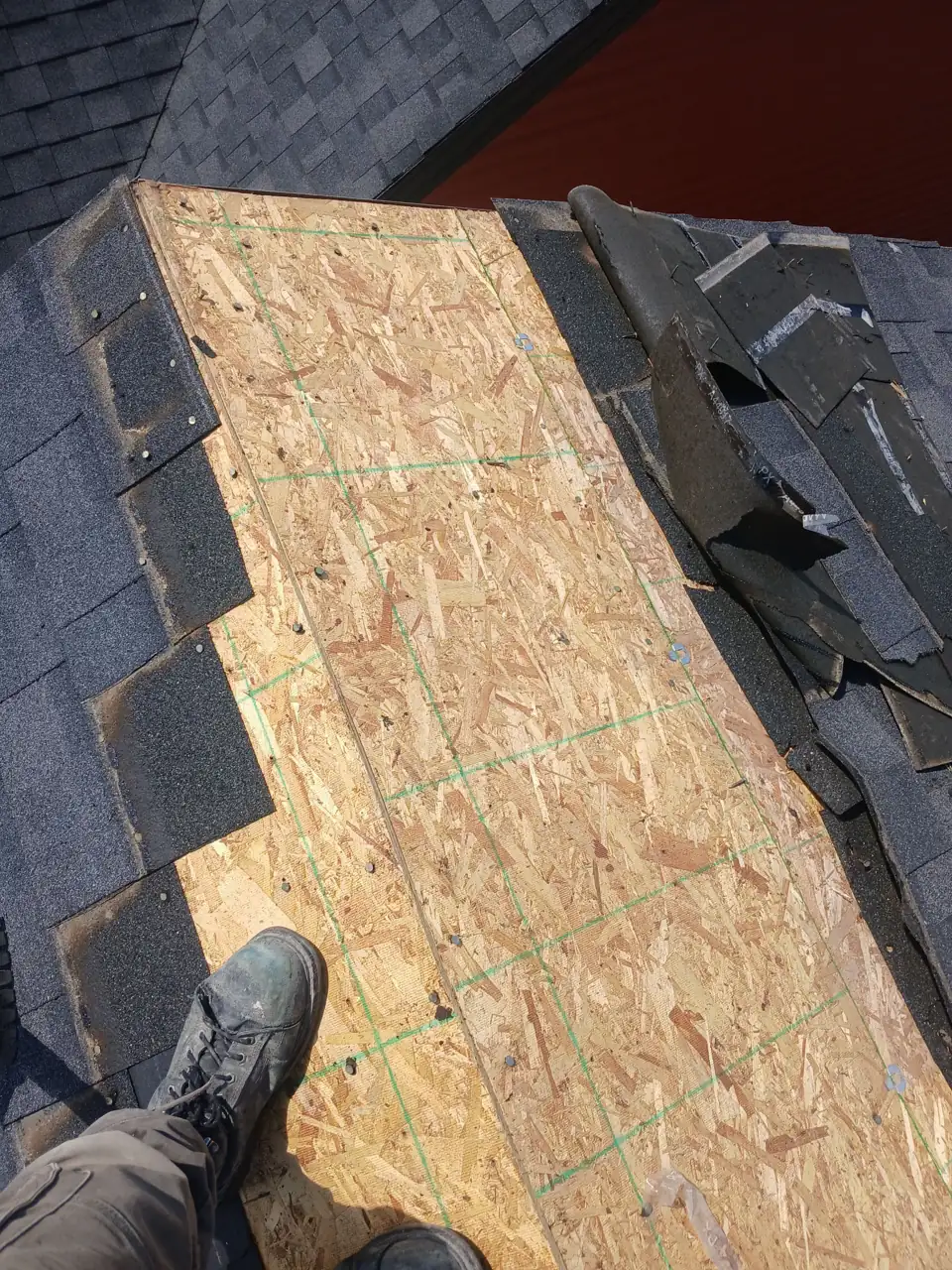Old shingles torn off exposing the roof decking
