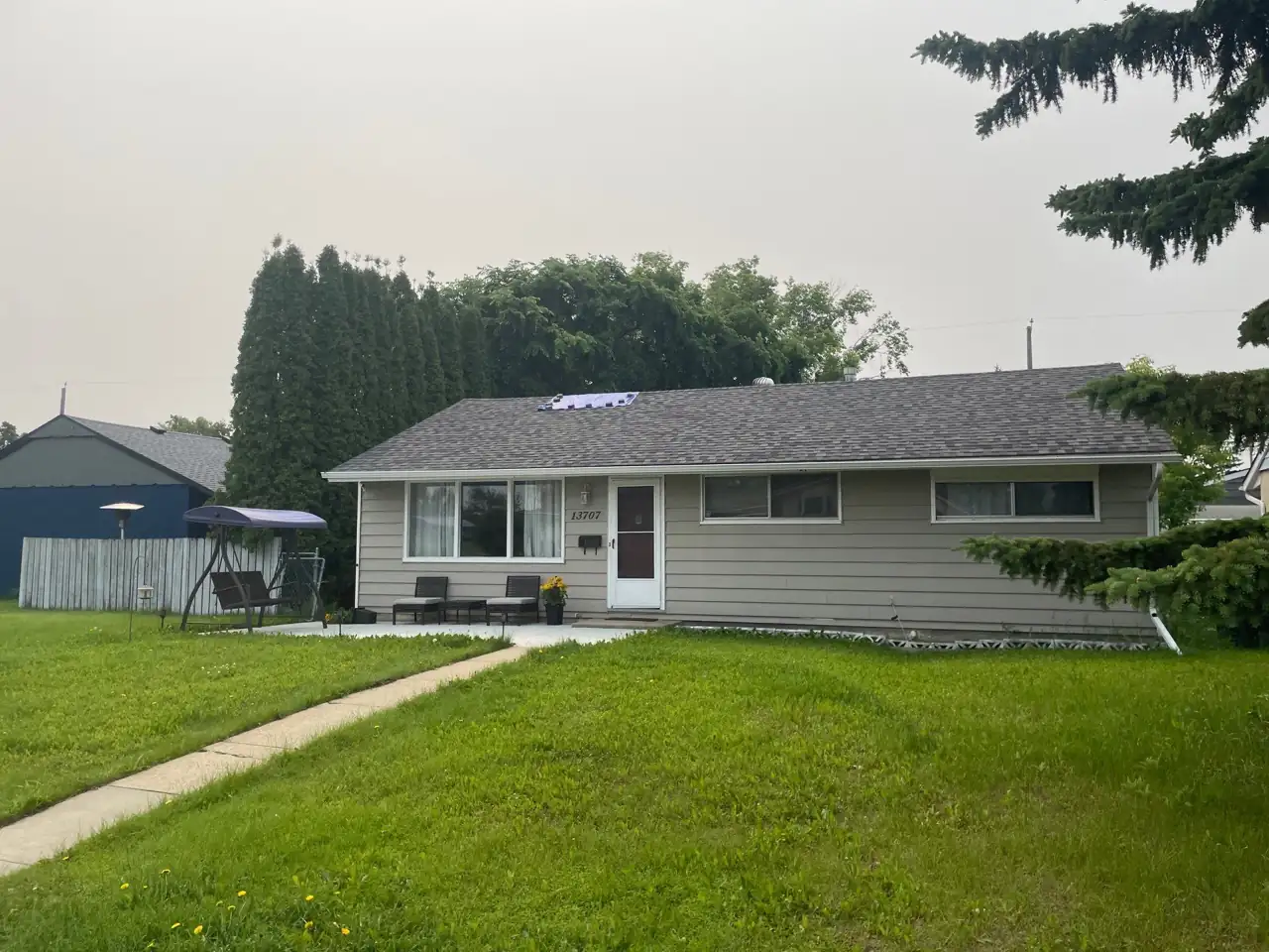 Roof in northwest Edmonton where wind-blown shingles were matched and replaced